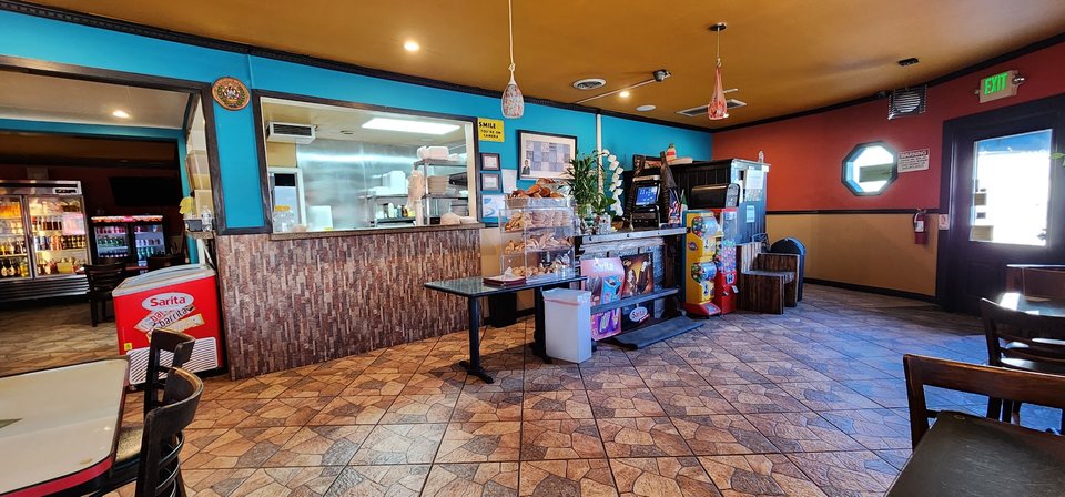 Casual Salvadoran dining room with simple tables.